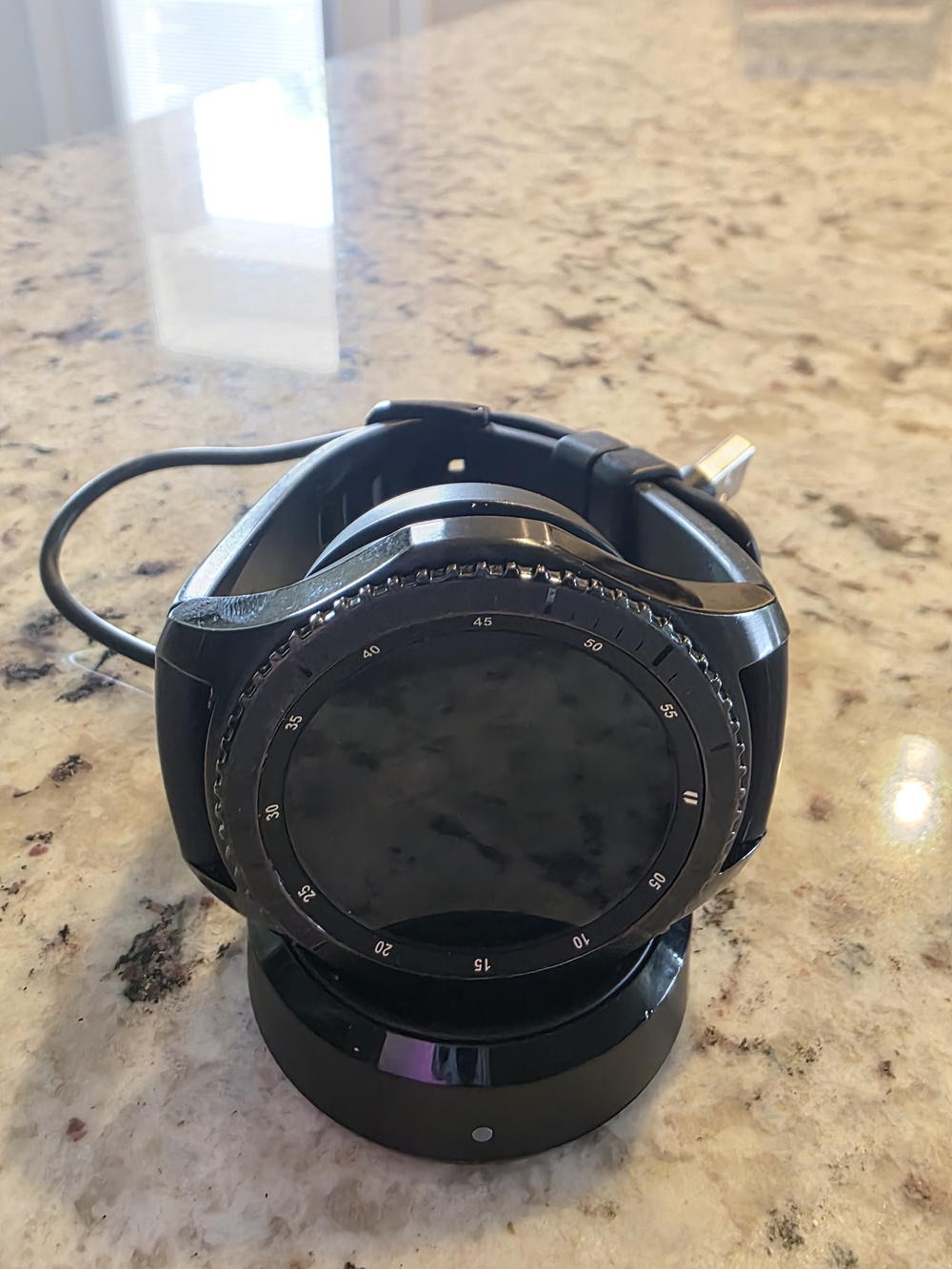 Black Round Samsung Smartwatch on Charging Dock